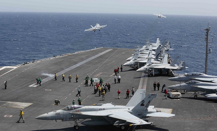 F/A18F Super Hornets launch from flight deck.