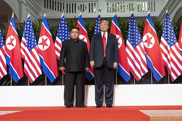 640px-Kim_and_Trump_standing_next_to_each_other