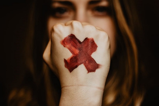 selective-focus-photography-of-woman-showing-her-left-hand-with-x-painting